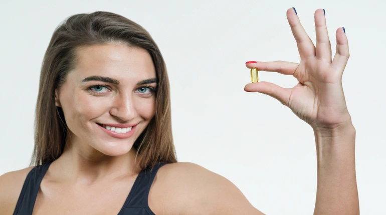 tomando tabletas de vitamina E